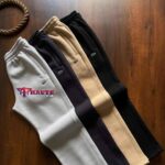 A matching set including a zip-up hooded sweatshirt and jogging pants.  - Image 2