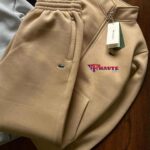 A matching set including a zip-up hooded sweatshirt and jogging pants. 